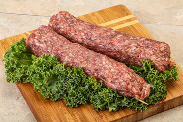 Raw minced beef kebab skewer