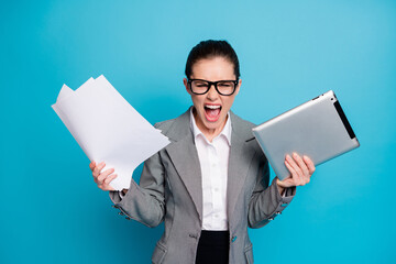 Portrait of attractive furious mad crazy lady specialist managing documentation burn-out isolated on bright blue color background