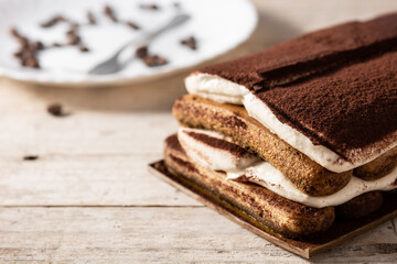 Traditional tiramisu cake on wooden table