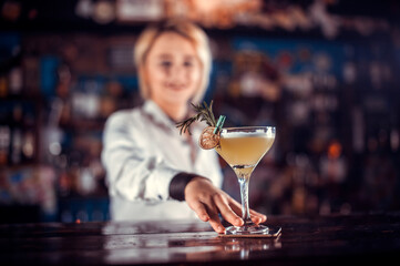 Girl barman concocts a cocktail at the brasserie