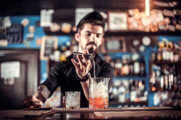 Barman creates a cocktail on the saloon