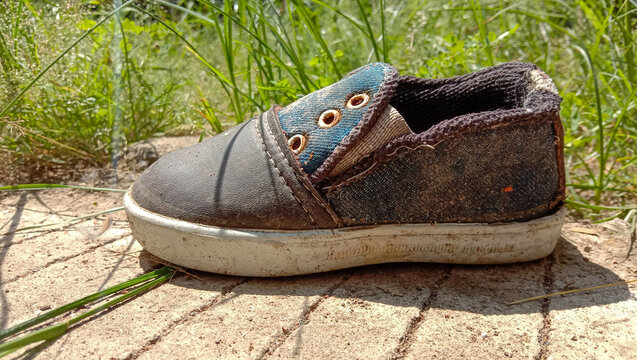 Used Boy Shoes On The Side Of The Road Next Door