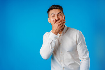 Young positive european man standing in blank white shirt laughing