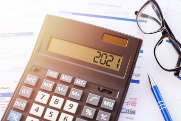 Word 2021 on the display of a calculator on financial documents.