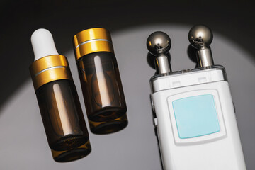 Gel and device for microcurrent stimulation of facial muscles on a gradient background, closeup