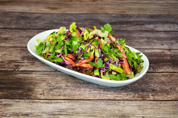 Traditional Turkish salad in the plate on wooden table