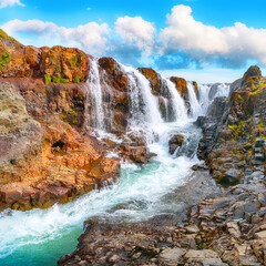 Majestic Kolufossar waterfall at summer sunny day.