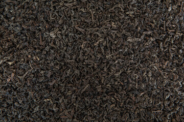 Dry black tea leaves texture background.
