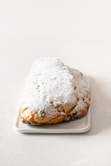 Christmas stollen - traditional German bread on white background. Close up. Vertical format.