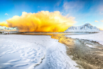 Outstanding  winter scenery on Skagsanden beach with illuminated clouds during sunrise.