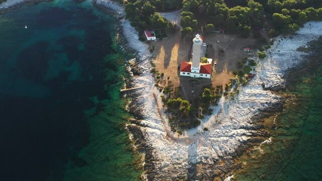 Aerial view of lighthouse tower of Veli Rat on the island of Dugi Otok, Croatia in early morning, Adriatic sea in background