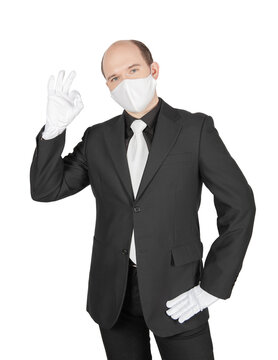 Business man with surgical medical virus protection white mask and gloves showing ok gesture isolated.