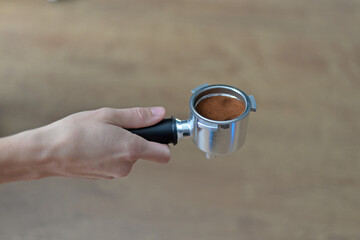 hand holding a coffee flask