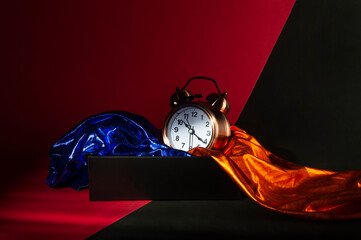 vintage alarm clock in a box with orange and blue cloth