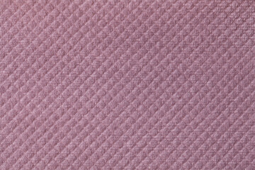 Texture of light purple fluffy fabric background with rhomboid pattern, macro.