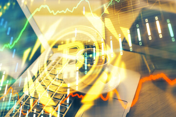 Multi exposure of blockchain and crypto economy theme hologram and table with computer background....