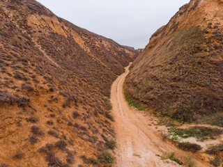 Aerial Shot of clay hills with canyons near the Black sea at Misty Autumn weather. Stanislavs mountains, Kherson region, Ukraine
