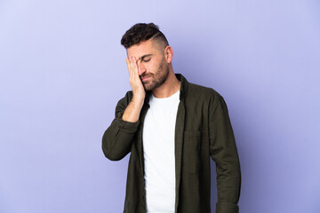 Caucasian man isolated on purple background with headache