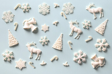 Christmas pattern of white holiday DIY decoration on blue. Xmas abstract background.