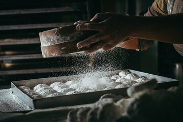 Close up of a baker preparing Greek traditional Kourabiethes, Christmas almond biscuits or cookies.