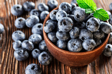 freshly picked blueberries close up with water drops on wood background