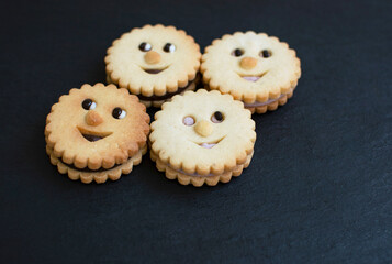 Creative cookies with face expressions on black background