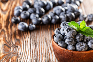 freshly picked blueberries close up with water drops on wood background