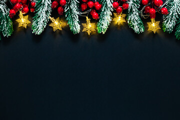 Christmas mockup with tinsel, holiday decorations on a dark backdrop. Winter mood, holly berries,...