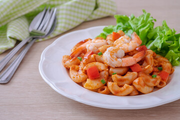 Stir fried macaroni with shrimp and vegetable on plate