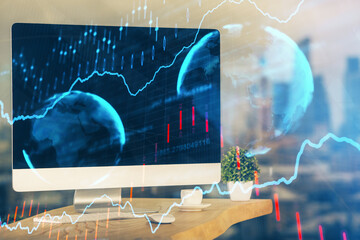 Financial chart drawing and table with computer on background. Double exposure. Concept of international markets.