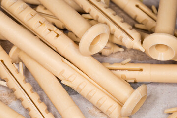 Pile of yellow plastic anchors, close-up in selective focus