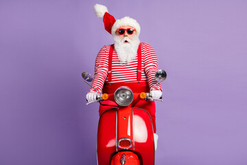Photo of shocked santa claus ride moped wear x-mas costume striped shirt cap glasses isolated...