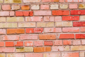 Obraz premium Old wall of cracked red and yellow bricks, background