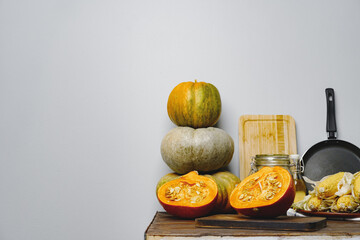 Pumpkins on kitchen table against grey wall