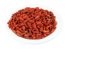 Dried goji berries in a plate on a white background