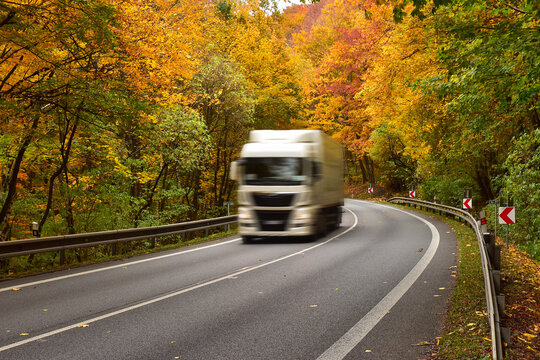 Truck transport carrier on the road in fall season
