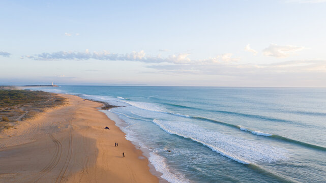 Aerial view beautiful of sea waves, sand from drone. Top view of the Faro de Trafalgar, blue water surface texture. Top view, amazing nature beach background. beach in Zahora, Cadiz, Andalusia, Spain.