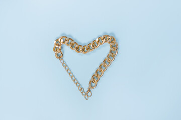 Gold Heart on blue background. Gold chain