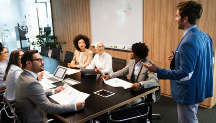 Business colleagues in conference meeting room during presentation