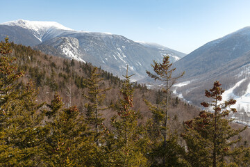 Obraz premium New Hampshire mountains - Cannon and Lafayette, Franconia Notch State Park. Snowy hills and rocks.