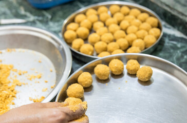 
besan laddoos are being made for festivals in india