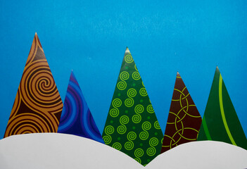 Christmas trees made of triangles on a blue background