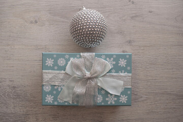 Christmas ball and gift box on a light background
