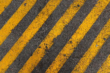 Yellow stripe pattern on asphalt parking lot space