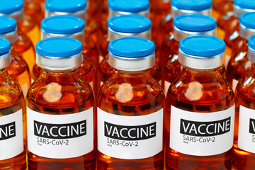 Sars-cov-2 vaccine vial bottles on white table