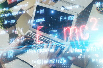 Science formula hologram with man working on computer on background. Education concept. Double...