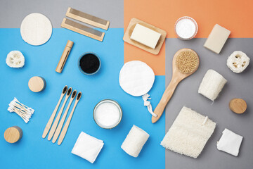 Creative layour of zero waste eco friendly personal care products wooden brushes, bamboo toothbrushes, luffa, natural soaps. Baking soda, coconut oil, activated charcoal. Top view, selective focus