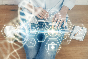 DNA hologram with businessman working on computer on background. Concept of bioengineering. Double...