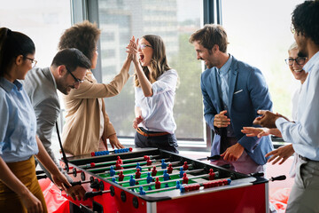 Excited diverse employees enjoying funny activity at work break, creative friendly workers play game - Powered by Adobe