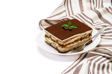 Traditional Italian Tiramisu square dessert portion on ceramic plate isolated on white